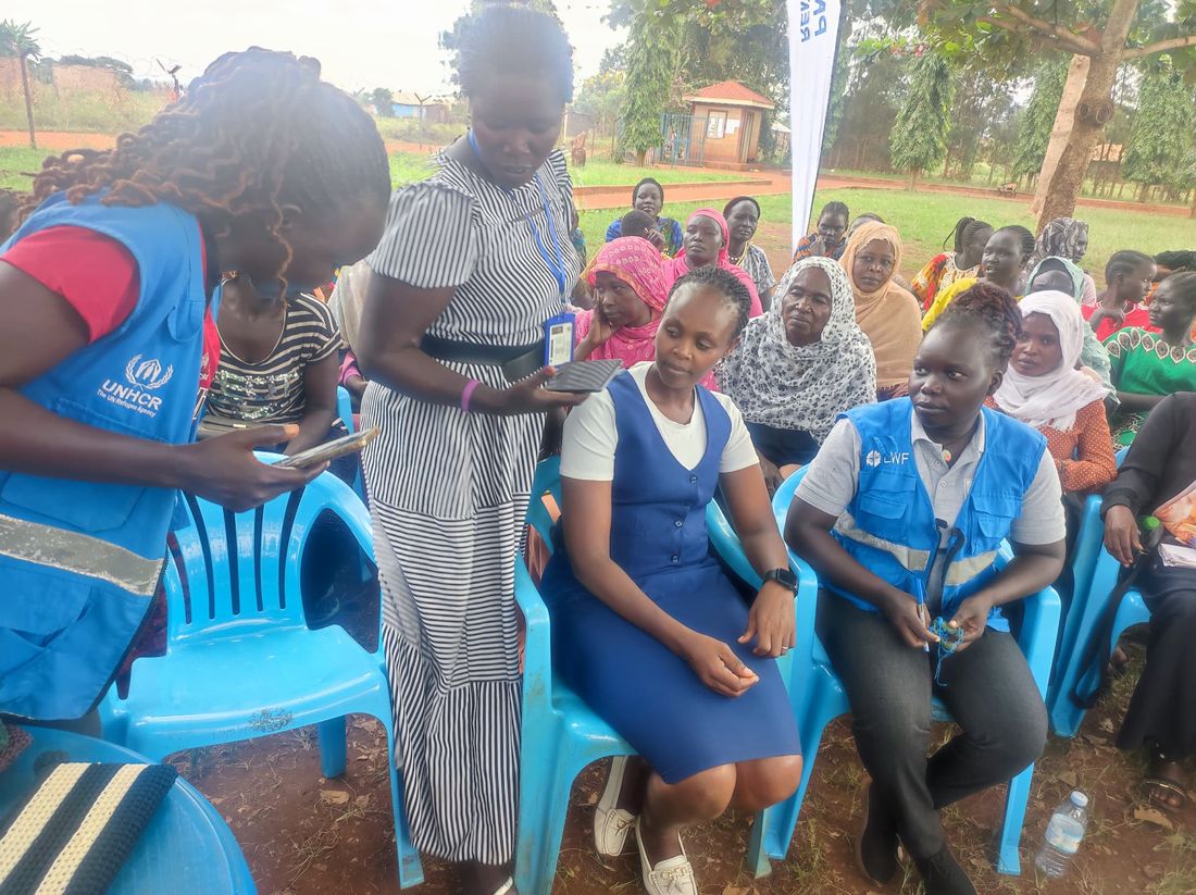 Community members seated together during the medical outreach in Kiryandongo Refugee Settlement