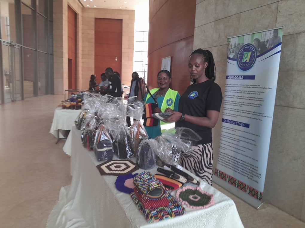 The display table of handmade goods beside the organisation banner