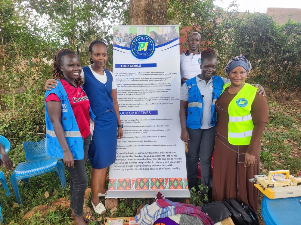 PhiphyMak staff and partner volunteers standing beside the organisation banner