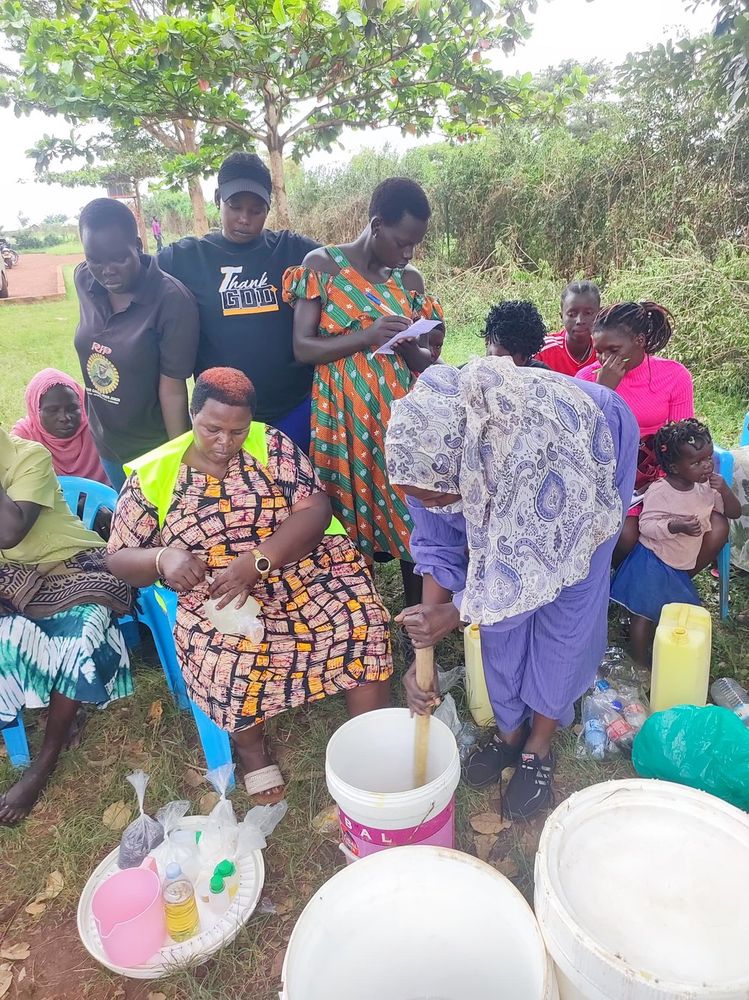 Women gathered around the soap making demonstration during the session