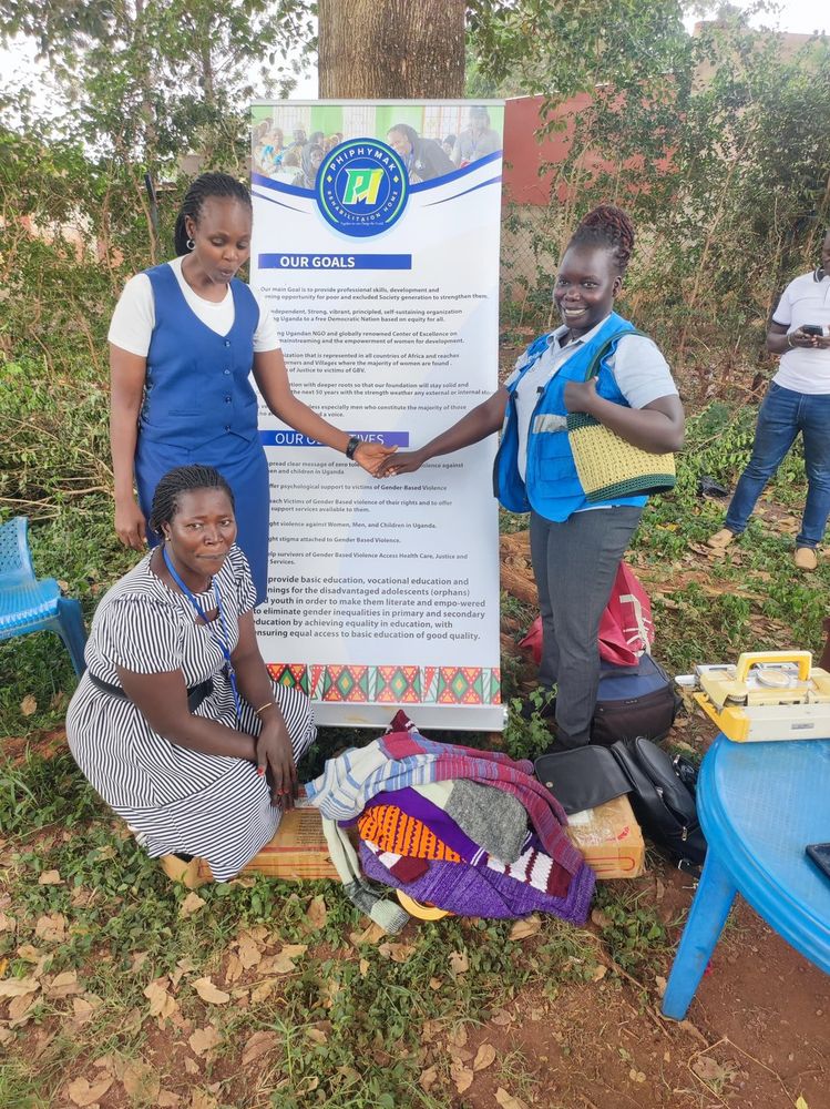 Team members standing with a participant beside the banner