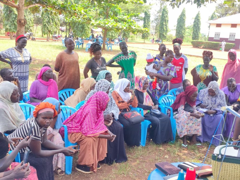 Women and children seated together during the outreach