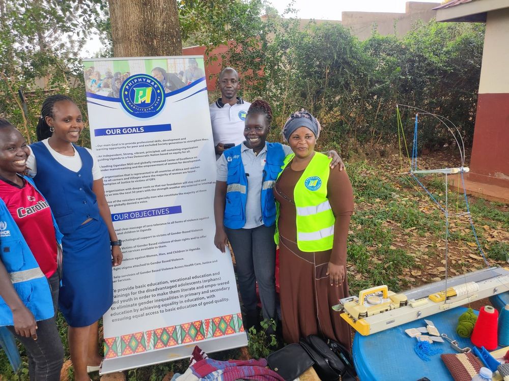 Team members and partner volunteers beside the banner