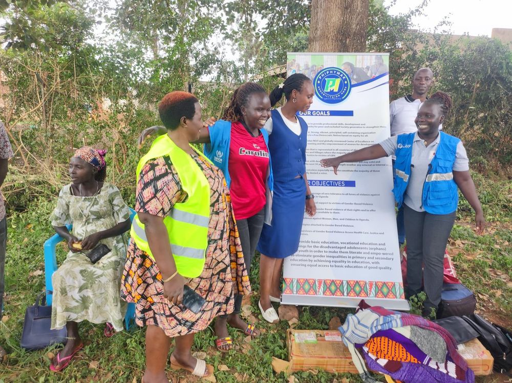 A team member pointing out details on the banner to volunteers
