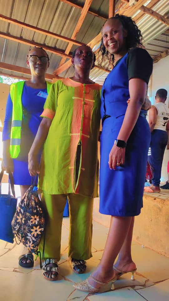 Team members and a community volunteer standing together at the centre