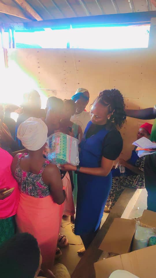 A team member handing out supplies to mothers inside the shelter
