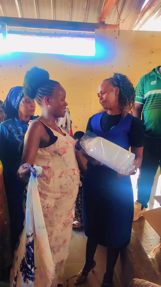 A mother receiving a package from a team member